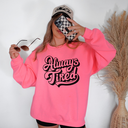 Always Tired on a neon pink sweatshirt