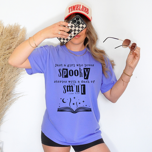 royal blue tshirt with "Just A Girl Who Loves Spooky Stories With A Dash Of Smut" on the front