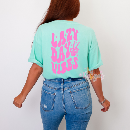 Mint color t-shirt with Lazy Day Vibes in a retro wavy, pink font on the back 