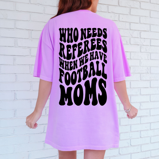 Person wearing a neon violet t-shirt with a humorous quote on the back against a white brick wall.